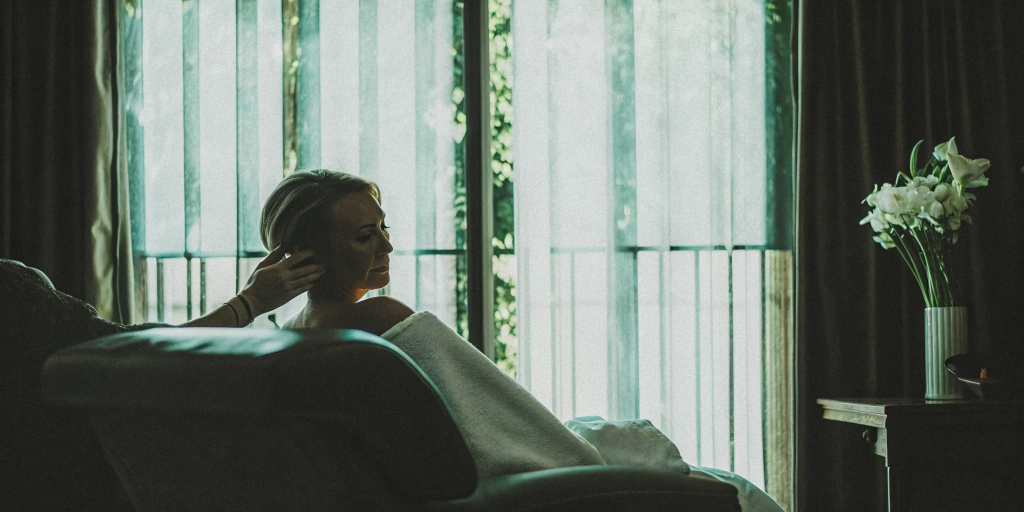 Woman relaxing in a spa chair after her arm fat removal near me treatment.