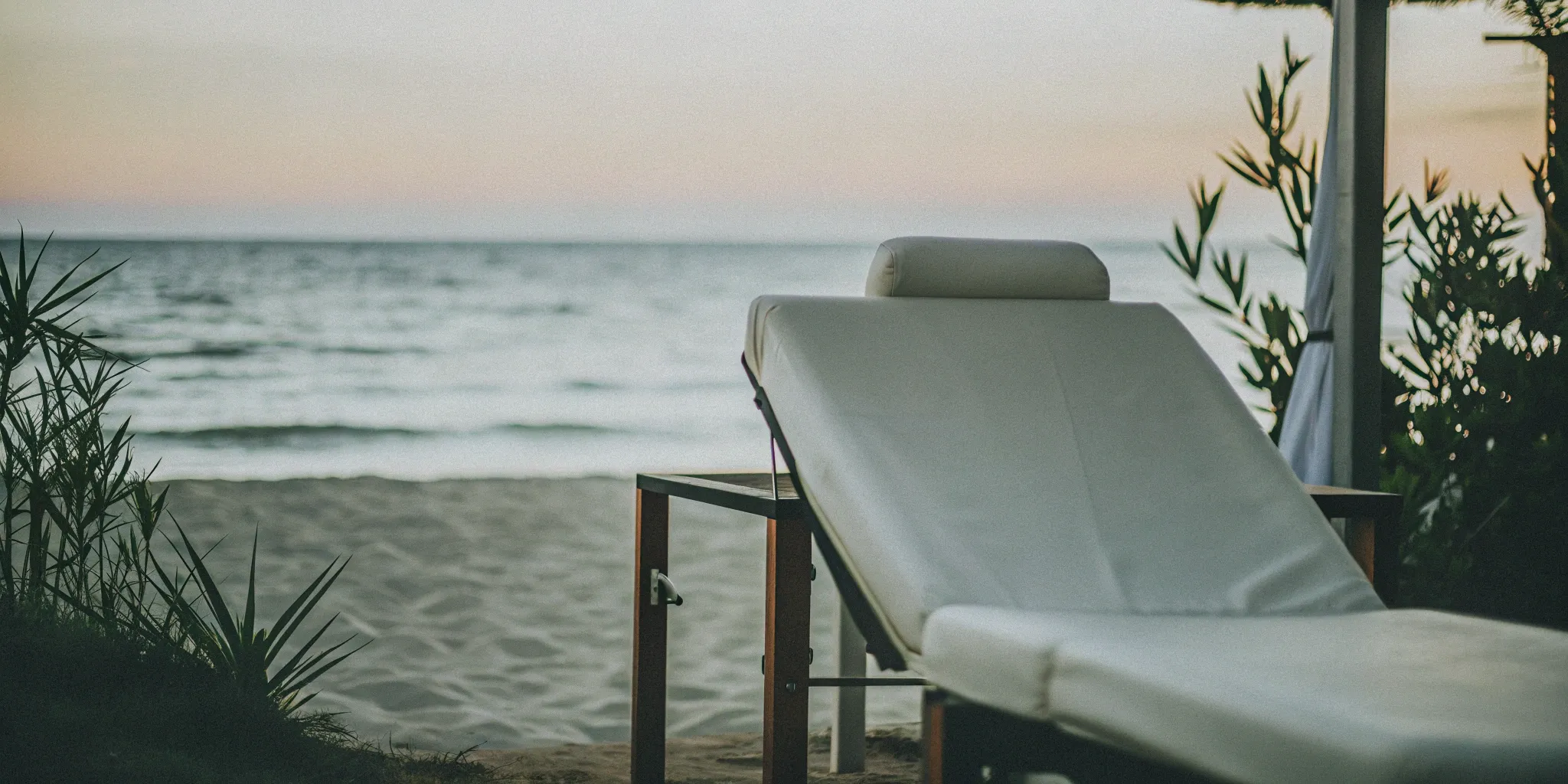 A treatment chair for laser hair removal on a sandy Virginia Beach shoreline.